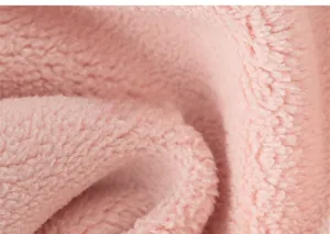 Close-up of soft pink plush fabric texture on children's hooded sweatshirt lining
