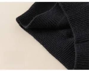 Macro detail of black ribbed knit hem on girl's winter sweater for flexible movement