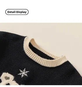 Detail view of winter knitted sweater featuring contrast crew neck and snowflake patterns