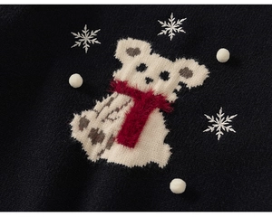 Detail of navy knit sweater with white bear pattern and red plush scarf for girls