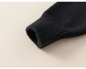 Detailed macro view of black knit sweater cuff with ribbed texture and soft fabric