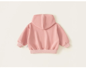 Detail view of the ribbed cuffs and hem on a dusty rose pink kids hooded sweatshirt