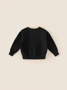 Girl's classic black knit sweater featuring a contrasting cream ribbed crew neck collar
