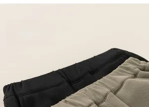 Detail of elastic waistband on kids cargo pants in black and army green colors