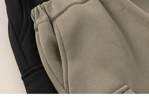 Detail of elastic waistband and stitching on boys' fleece-lined cargo sweatpants