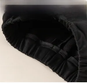 Detail of the elastic waistband and thick fleece lining on boys' black cargo pants