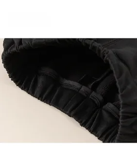 Detailed macro view of the elastic waistband and stitching on boys' fleece-lined trousers