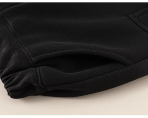 Macro shot of elastic waistband and side pocket on black fleece-lined joggers