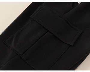 Detailed macro view of black cargo pants pocket featuring clean stitching and thick fabric