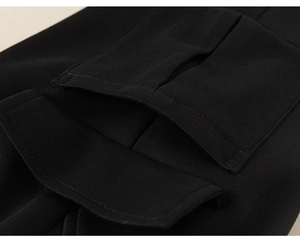 Close-up of black boys cargo pants showing pocket details and durable woven fabric