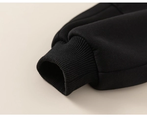 Detail shot of the thick ribbed cuff and knitting fabric of black thermal trousers