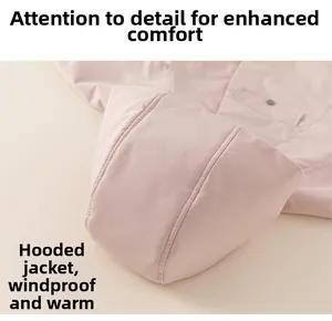 Detail view of pink girl hooded coat showing windproof material and fine stitching