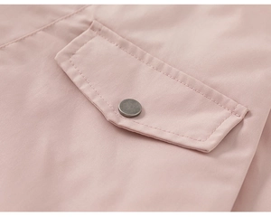 Close-up of pink winter coat with a flap pocket and vintage silver metal button detail