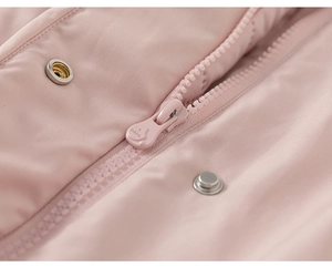 Detail of light pink kids jacket with matching zipper, metal buttons, and fine stitching