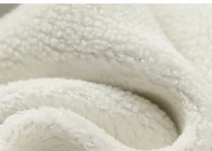 Detail of warm white sherpa fleece lining showing soft texture and thick plush fabric