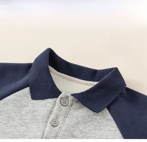 Close-up of classic polo collar and button placket on gray and navy color-block sweatshirt
