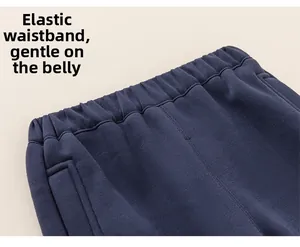 Detail of navy blue fleece joggers featuring a flexible elastic waistband for comfortable fit