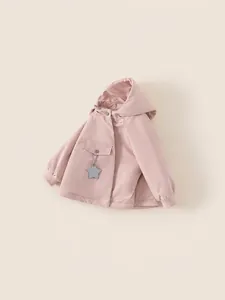 Girl's pink hooded winter coat with star accessory and ribbed cuffs on beige background