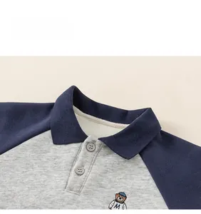 Detail view of child sweatshirt with polo collar, bear embroidery, and raglan sleeves