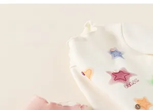 Detail of fleece-lined kids shirt with ruff collar and colorful star patterns