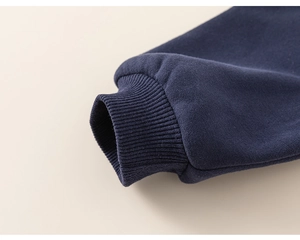Detail of ribbed cuffs on navy blue fleece sweatshirt for kids with windproof design