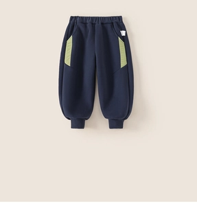 Detail view of navy blue kids fleece joggers with green side pockets and elastic ankle cuffs