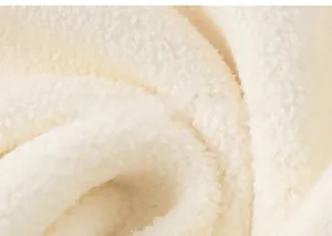 Detailed macro view showing soft creamy fleece texture and thick inner lining of kid's sweater
