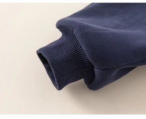 Close-up of elastic ribbed cuffs on dark blue thick cotton winter sweatshirt for boys