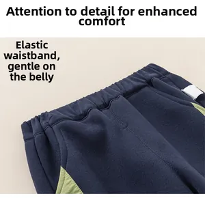 Detailed close-up of elastic waistband on dark blue boys' cotton sports trousers