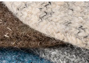 Close-up of chunky knit fabric texture showing mixed beige, brown and blue yarn layers