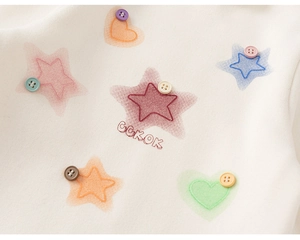 Detail of cotton sweatshirt featuring colorful star embroidery and decorative buttons