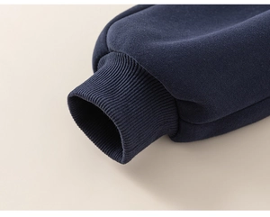 Close-up of dark blue ribbed ankle cuffs on thick fleece-lined boys' sweatpants