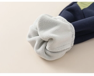 Detail of warm white fleece lining and navy knit fabric on boys winter sports pants