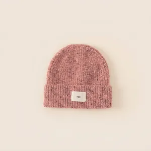 Pink chunky knit beanie for girls with ribbed texture and white agg letter patch