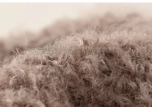 Macro close-up of dark coffee plush knit fabric showing thick thermal texture