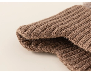 Close-up of thick rib-knit texture on kids winter hat in deep coffee brown wool