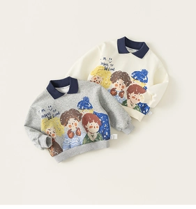 Detailed view of kids' polo collar sweatshirts with cartoon prints in grey and cream