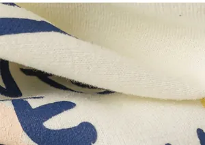 Macro shot of soft beige cotton blend fabric with blue and pink letter prints