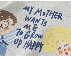 Close-up of heather gray cotton fabric with cartoon boy and girl graffiti print details