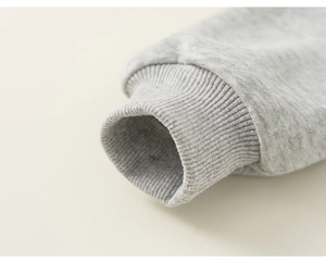 Detail shot of light grey knit ribbed cuffs on a cotton sweatshirt for children