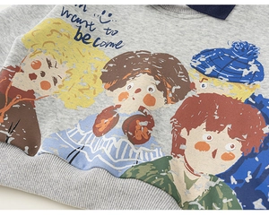 Detail of light grey kids sweatshirt featuring cartoon print and ribbed hem finish