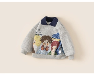 Detail of grey children's polo sweatshirt featuring cartoon print and navy blue collar