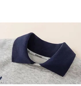Detail shot of navy blue ribbed collar on gray sweatshirt with inside neck tape