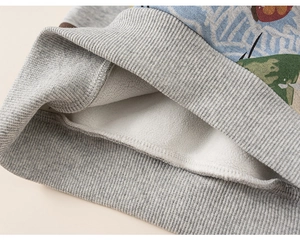 Close-up of kids sweatshirt featuring warm white fleece lining and grey ribbed cuffs