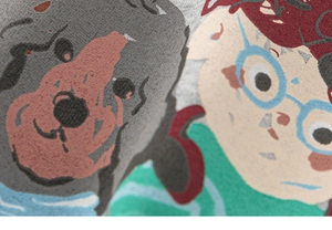 Close-up of kids' sweatshirt with cartoon dog and boy print on grey knit fabric