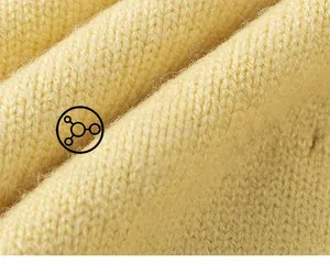 Macro detail of soft yellow knit fabric with V-shaped texture for children's cardigan