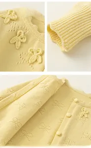 Detail view of knit cardigan with 3D bow decoration, ribbed cuffs, and matching buttons