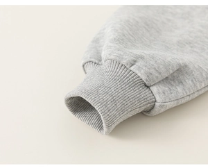 Close-up of light grey cotton knit sleeve cuff with high-quality elastic ribbing detail