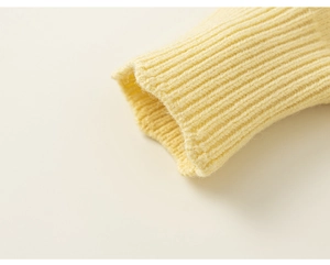 Macro shot of cream knit ribbed cuffs showing soft texture and elastic weave details