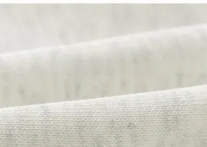 Close-up of soft grey knit fabric texture showing high-quality breathable material